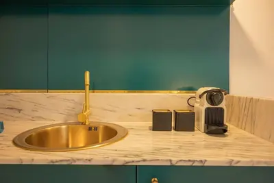 a kitchen counter with a sink and a radio at Touchy Porto in Porto