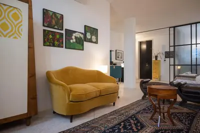 a living room with a yellow couch and a table at Touchy Porto in Porto