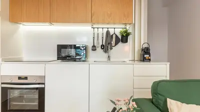 a kitchen with a sink and a counter with utensils at Old Town 1BR Duplex by LovelyStay in Porto