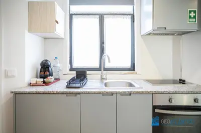 a kitchen counter with a sink and a window at Porto Formosa Central Lofts in Porto