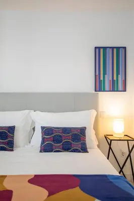 a white bed with two pillows on top of it at Porto Formosa Central Lofts in Porto