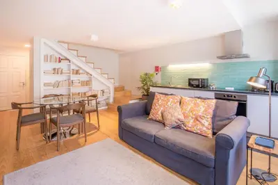 a living room with a couch and a table at Almada 151 Porto in Porto