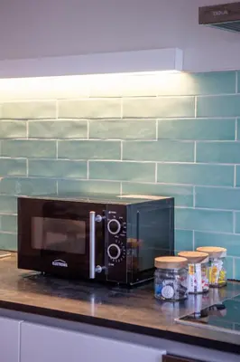 a microwave sitting on a counter in a kitchen at Almada 151 Porto in Porto