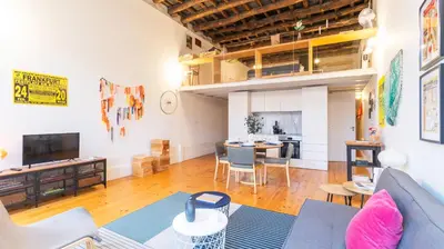 a living room with a couch and a table at Eccentric Mouzinho Mezzanine by LovelyStay in Porto