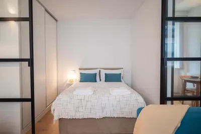 a bedroom with a large bed with blue pillows at Santa Catarina Charm Apartment Downtown near Metro in Porto