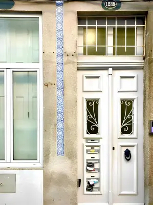 a building with a white door and two windows at Santa Catarina Charm Apartment Downtown near Metro in Porto
