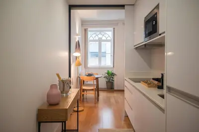 a kitchen with a table and a dining room at Santa Catarina Charm Apartment Downtown near Metro in Porto