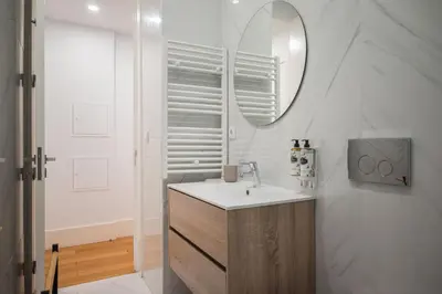 a bathroom with a sink and a mirror at Santa Catarina Charm Apartment Downtown near Metro in Porto