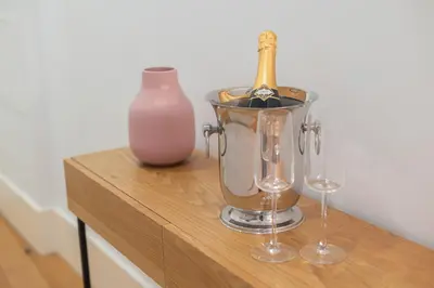 a bottle of wine in a blender next to two wine glasses at Santa Catarina Charm Apartment Downtown near Metro in Porto