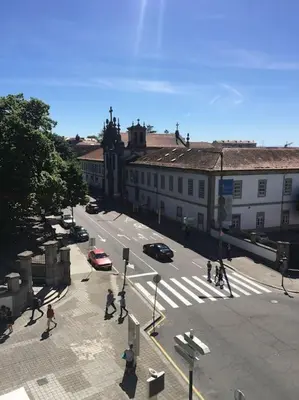 a group of people crossing a street in a city at Studio Jardim São Lázaro in Porto