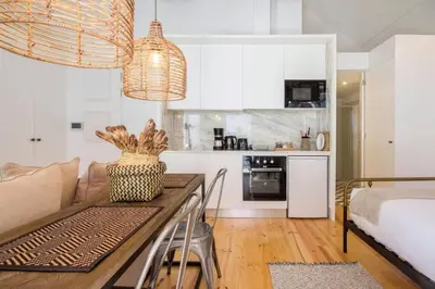 a kitchen and living room with a table and a couch at 157 Flores Apartment in Porto