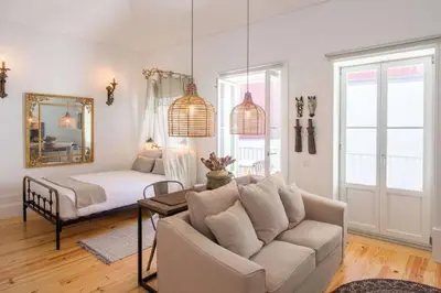 a living room with a couch and a bed at 157 Flores Apartment in Porto