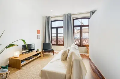 a living room with a bed and a tv at Hey Apartments C in Porto