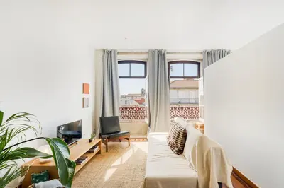 a living room with a couch and a large window at Hey Apartments C in Porto