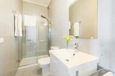 a white bathroom with a sink and a toilet at Hey Apartments C in Porto