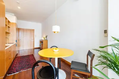 a dining room with a yellow table and chairs at Hey Apartments C in Porto