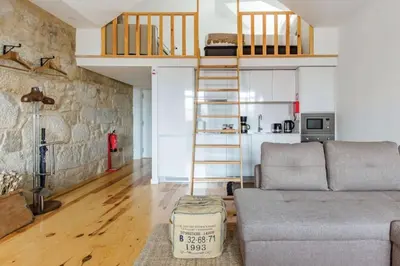 a living room with a couch and a loft at 1892 - Ribeira Loft in Porto