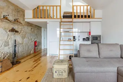 a living room with a couch and a loft at 1892 - Ribeira Loft in Porto