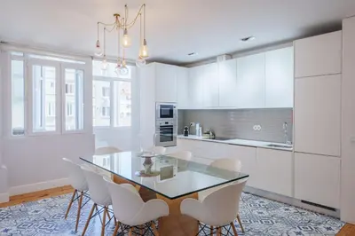 a kitchen and dining room with a table and a window at Feel Porto Downtown Apartments & Studios in Porto