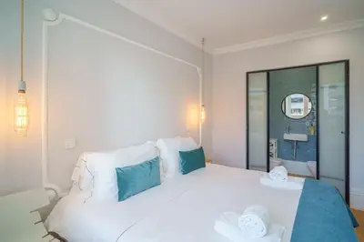 a kitchen and dining room with a wooden table and chairs at Feel Porto Downtown Apartments & Studios in Porto