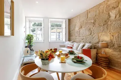 a living room with a table and a couch at Oporto Cosy Apartment in Porto