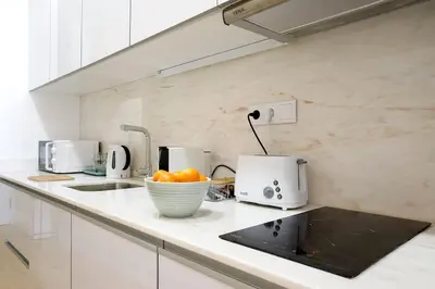a kitchen with a counter with a bowl of oranges at Oporto Cosy Apartment in Porto