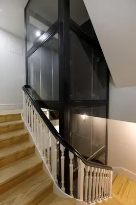 a staircase with a glass case in a house at Oporto Lovely Apartment in Porto