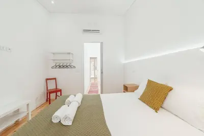a bedroom with a white bed with towels on it at Modern Villa by Hosty in Porto