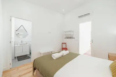 a white bedroom with a bed and a sink at Modern Villa by Hosty in Porto
