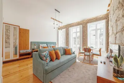 a living room with a couch and a table at Constituição Deluxe by Hosty in Porto