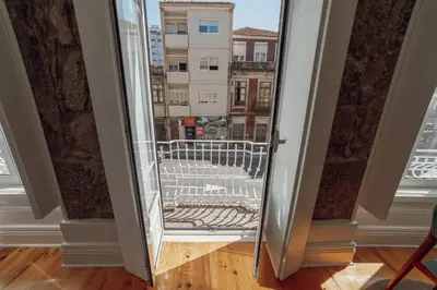 a door to a balcony with a view of a city at Constituição Deluxe by Hosty in Porto