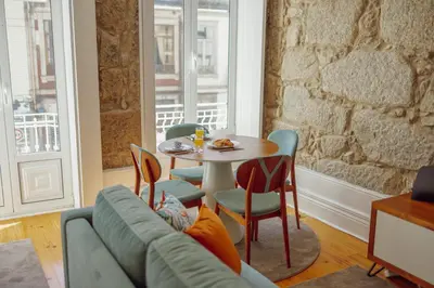 a living room with a table and a couch at Constituição Deluxe by Hosty in Porto