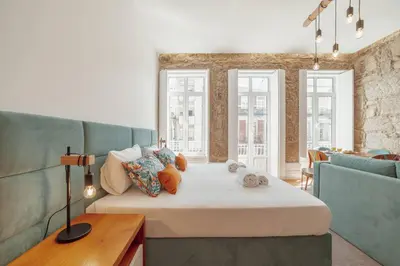a bedroom with a large bed with stuffed animals on it at Constituição Deluxe by Hosty in Porto