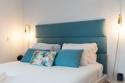 a white bed with two pillows on top of it at Mouzinho Rooftop View in Porto