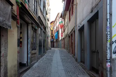 an empty alley way in a city with buildings at Mouzinho Rooftop View in Porto