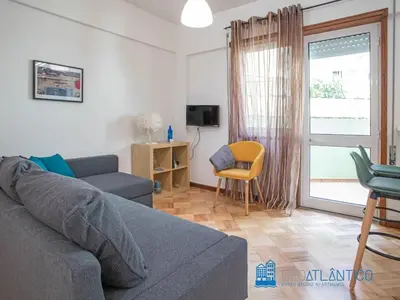 a living room with a couch and a chair at Porto Sé Classic Terrace Apartment in Porto