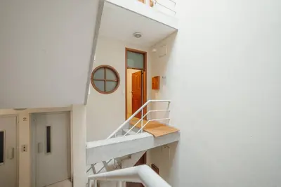 a staircase in a white building with a mirror at Flores Deluxe by Hosty in Porto