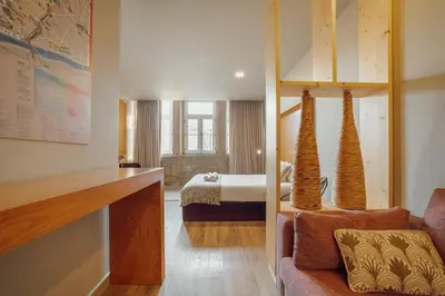 a hotel room with a bedroom with a bed at Flores Deluxe by Hosty in Porto