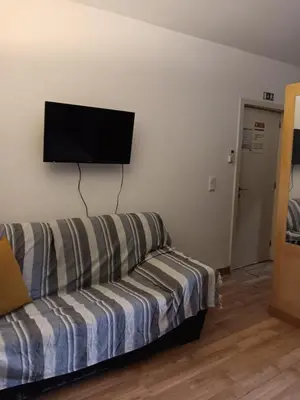 a living room with a couch and a flat screen tv at Porto Centro Station in Porto