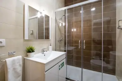 a bathroom with a sink and a glass shower at Modern Living - Santa Catarina in Porto