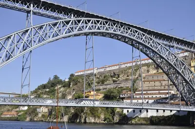 a bridge over the water with a train on it at Modern Living - Santa Catarina in Porto