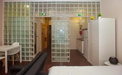 a room with glass block walls and a refrigerator at Bonsai Apartment 5 in Porto