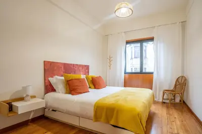a white bedroom with a bed and a window at Sublime Downtown Retreat by ELSA, 180m2 in Porto