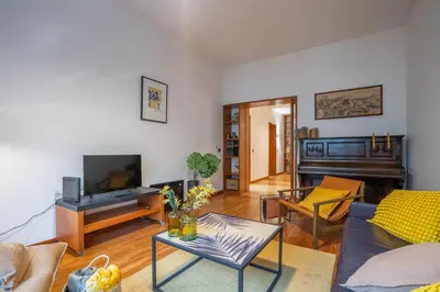a living room with a couch and a piano at Sublime Downtown Retreat by ELSA, 180m2 in Porto