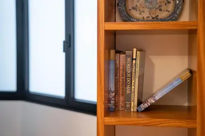 a book shelf with books and a clock on it at Sublime Downtown Retreat by ELSA, 180m2 in Porto