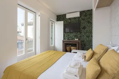 a bedroom with a large bed and a window at S. Bento Downtown Apt in Porto