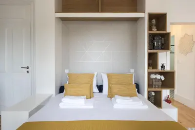 a bedroom with a white bed with two pillows at S. Bento Downtown Apt in Porto