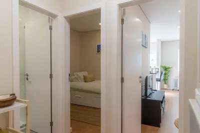 a room with a bedroom with a bed and a mirror at Morro Garden Apartment by Hosty in Vila Nova de Gaia