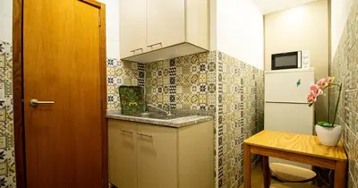 a small kitchen with a sink and a refrigerator at Casa do Recanto - Studio in Porto