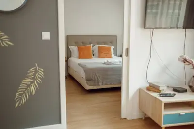 a bedroom with a bed with orange pillows at Coliseu Apartment by Hosty in Porto